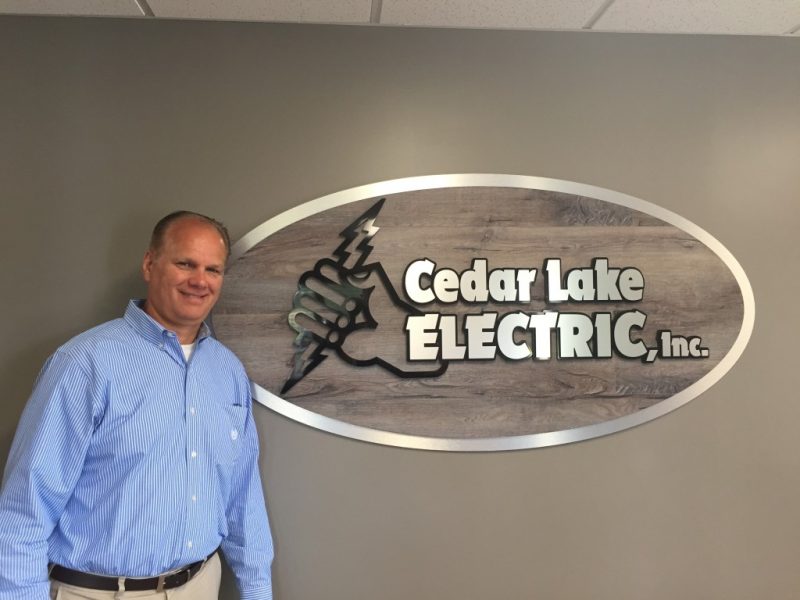 Jay Valentyn with New Office Signage